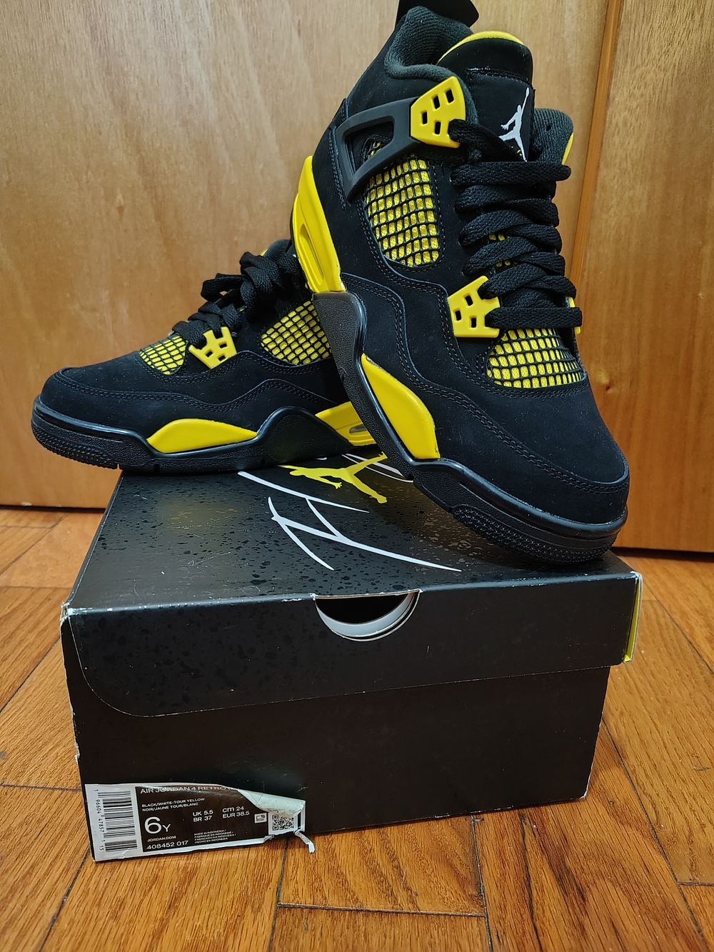 Jordan Men’s Black and Yellow Air Jordan 4 Sneakers